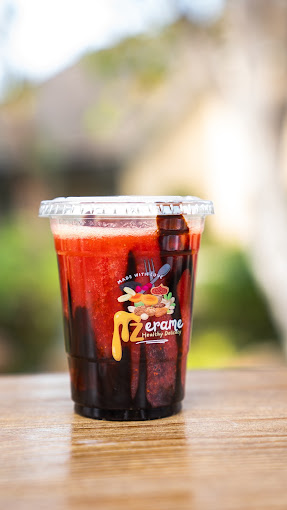 An iced strawberry refresher on a wood table